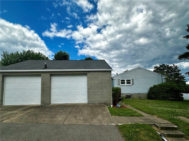 garage featuring a lawn