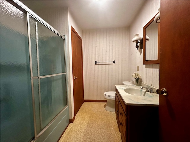 bathroom featuring toilet, walk in shower, and vanity