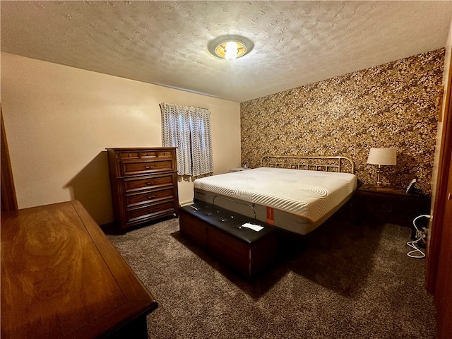 bedroom with a textured ceiling and carpet