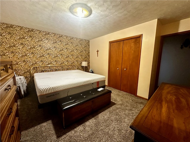 carpeted bedroom with a closet and a textured ceiling