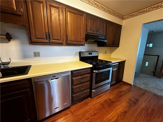 kitchen with dark hardwood / wood-style flooring, sink, and appliances with stainless steel finishes