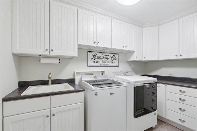 clothes washing area featuring washing machine and clothes dryer, sink, light tile patterned flooring, and cabinets