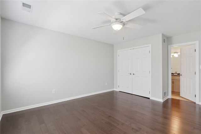 unfurnished bedroom featuring a closet, dark hardwood / wood-style floors, and ceiling fan