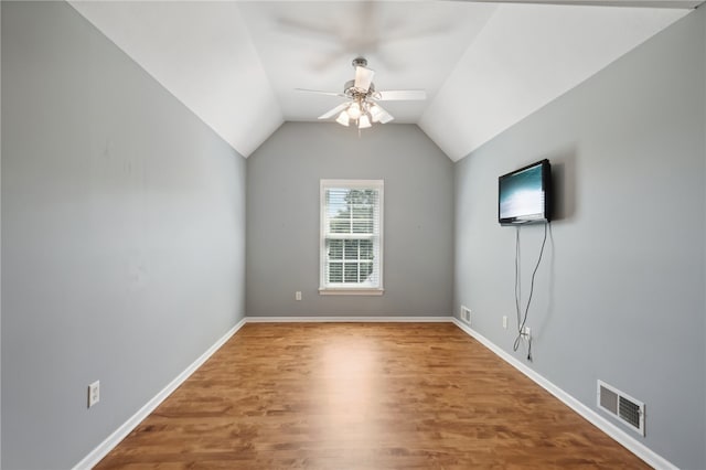 interior space with ceiling fan, hardwood / wood-style floors, and lofted ceiling