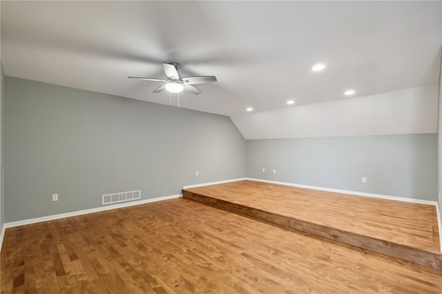 additional living space with ceiling fan, hardwood / wood-style floors, and lofted ceiling