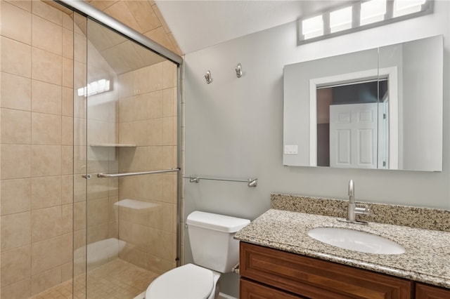 bathroom with a shower with shower door, toilet, lofted ceiling, and vanity