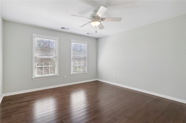 empty room with dark hardwood / wood-style floors and ceiling fan