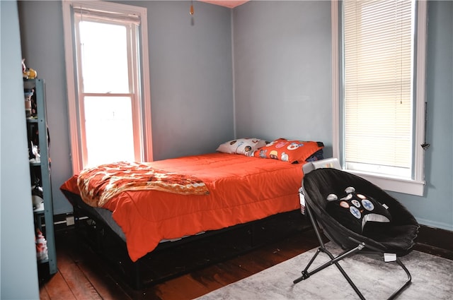 bedroom with dark wood-type flooring