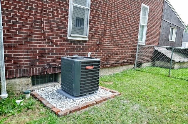 exterior details featuring central air condition unit and a wood stove