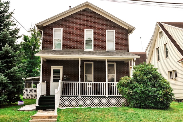 view of front facade with a front lawn and covered porch