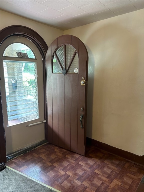 foyer entrance with dark parquet flooring