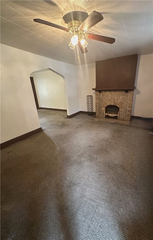 unfurnished living room featuring carpet floors and ceiling fan