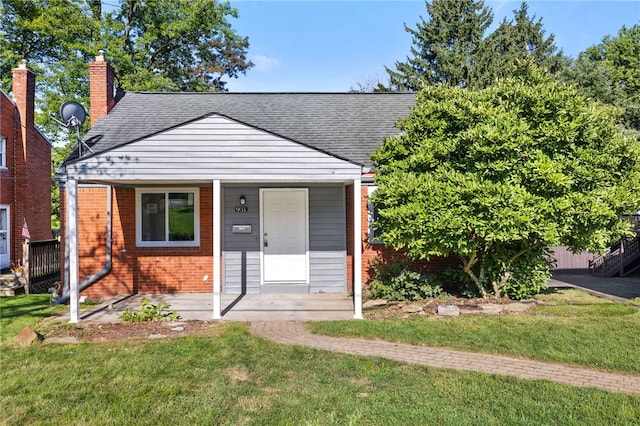 bungalow-style home featuring a porch and a front yard