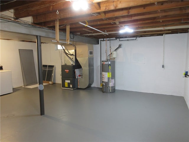 basement with heating unit, washer / dryer, and water heater