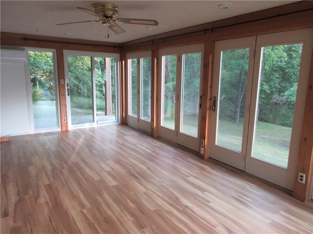 unfurnished sunroom with plenty of natural light and ceiling fan