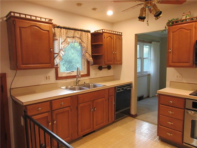 kitchen featuring black dishwasher, ceiling fan, sink, and oven