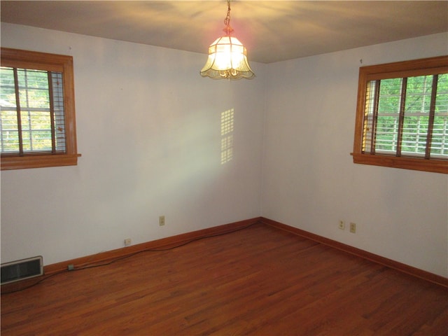 spare room with dark wood-type flooring