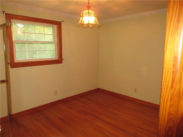 empty room with dark hardwood / wood-style flooring and crown molding