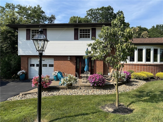 view of front of house with a garage and a front lawn