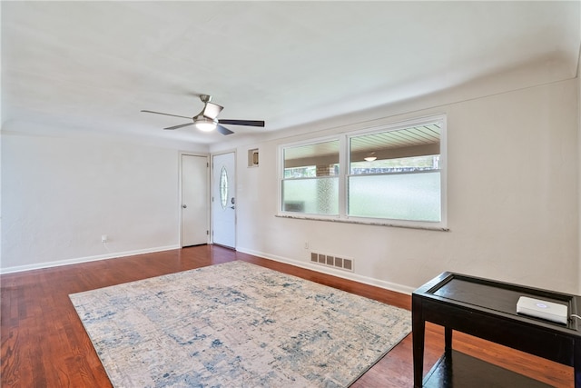 interior space featuring ceiling fan and dark hardwood / wood-style flooring