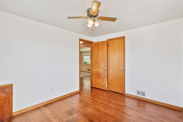 spare room featuring ceiling fan and wood-type flooring