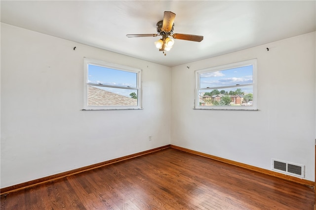 empty room with ceiling fan and wood-type flooring