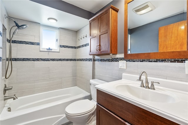 full bathroom featuring backsplash, toilet, vanity, tile walls, and tiled shower / bath combo