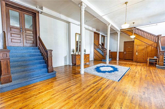 basement featuring light hardwood / wood-style flooring and french doors