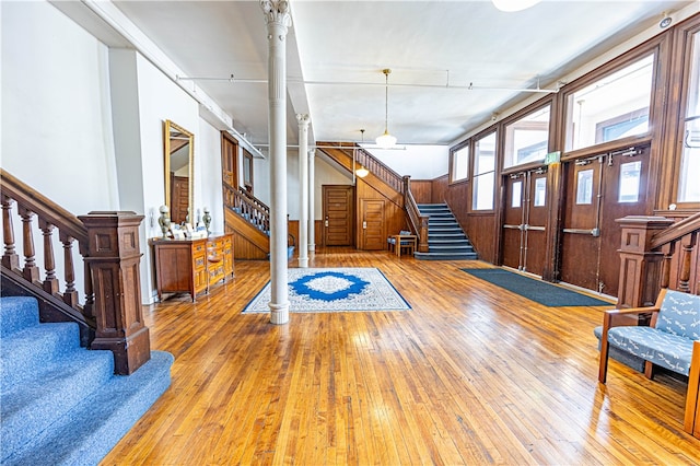 entrance foyer with hardwood / wood-style floors and ornate columns