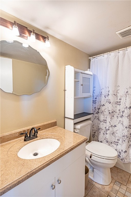 bathroom with toilet, vanity, curtained shower, and tile patterned floors