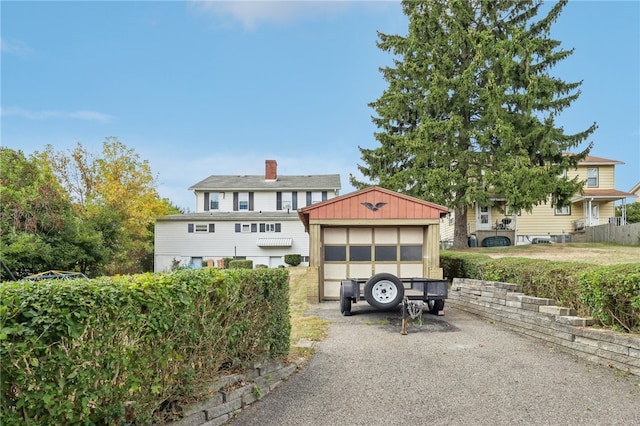 view of front of house featuring an outdoor structure and a garage