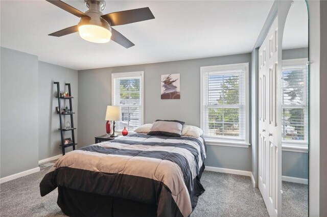 bedroom with a closet, ceiling fan, and carpet