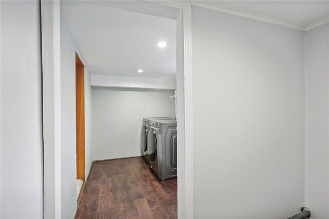 washroom featuring independent washer and dryer, crown molding, and dark hardwood / wood-style flooring