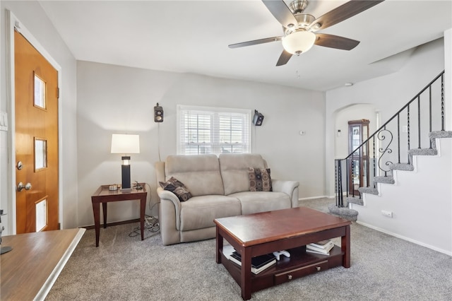 carpeted living room featuring ceiling fan