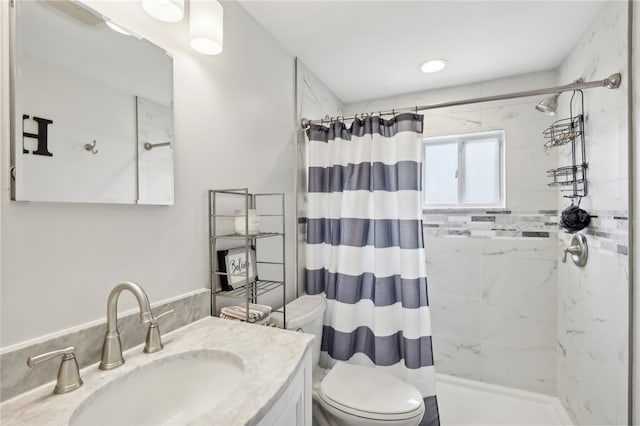 bathroom with curtained shower, vanity, and toilet