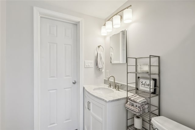 bathroom with toilet and vanity