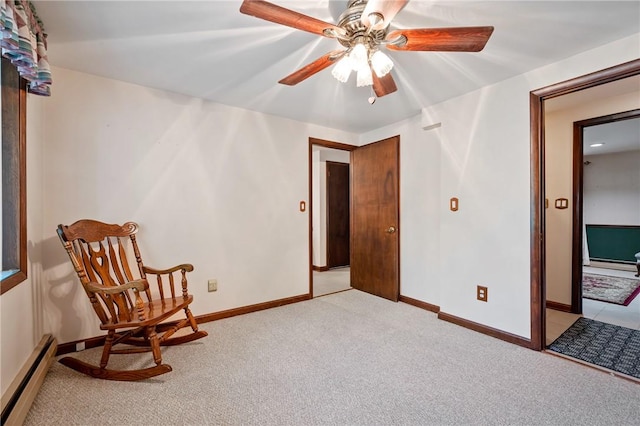 sitting room featuring light carpet, ceiling fan, and a baseboard radiator