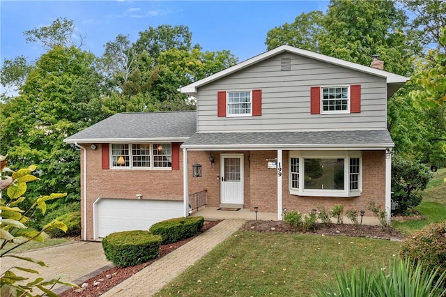 view of front of home featuring a garage and a front lawn