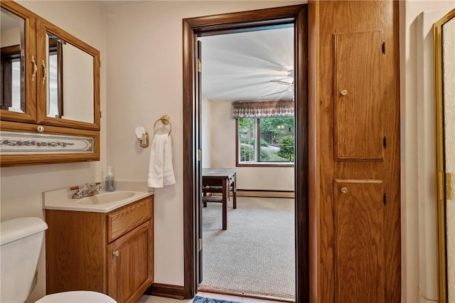 bathroom with vanity, a baseboard radiator, and toilet