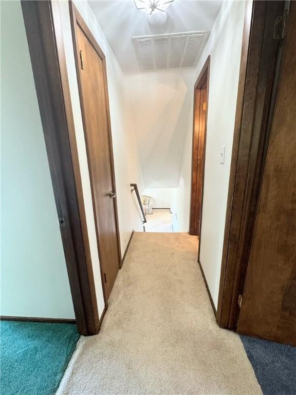 hall with light colored carpet