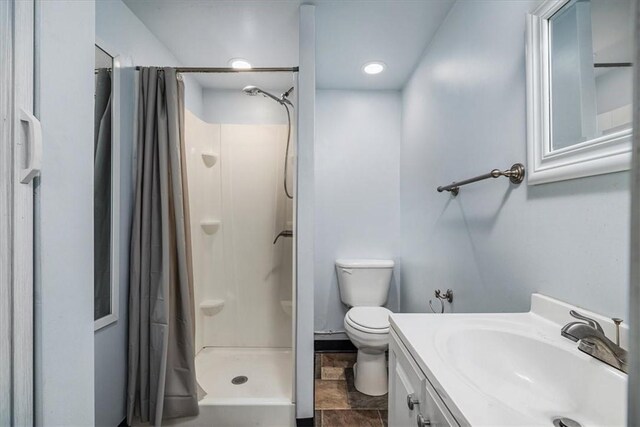 bathroom with toilet, vanity, a shower with curtain, and tile patterned floors