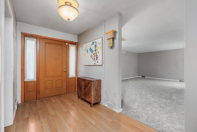 entrance foyer featuring light wood-style flooring and baseboards