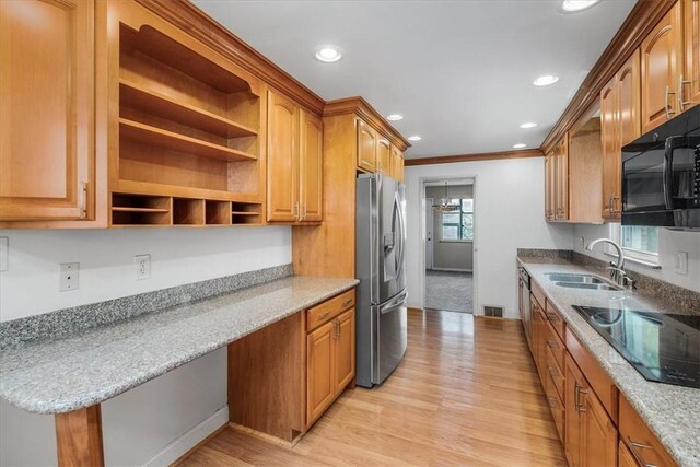 kitchen with light hardwood / wood-style flooring, ornamental molding, sink, black appliances, and light stone countertops