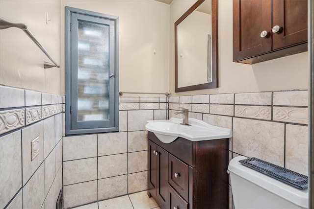 bathroom featuring tile walls, tile patterned flooring, vanity, and toilet