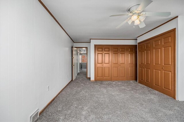 unfurnished bedroom with ceiling fan, ornamental molding, and light carpet