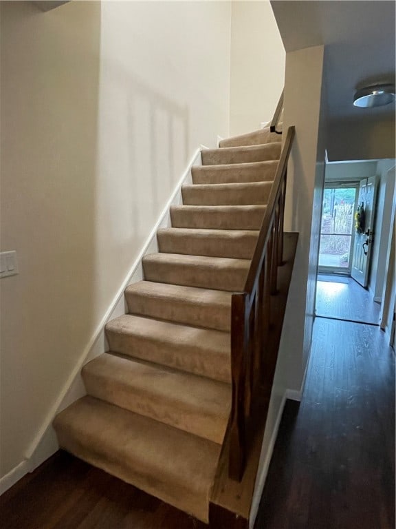 stairs with hardwood / wood-style floors