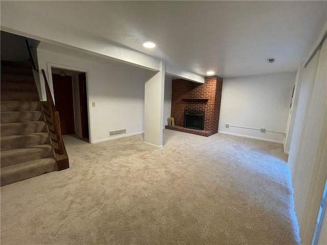 unfurnished living room featuring light colored carpet and a fireplace