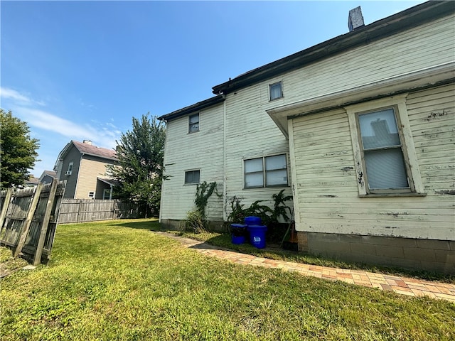 rear view of property with a yard