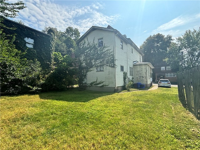 view of property exterior featuring a lawn