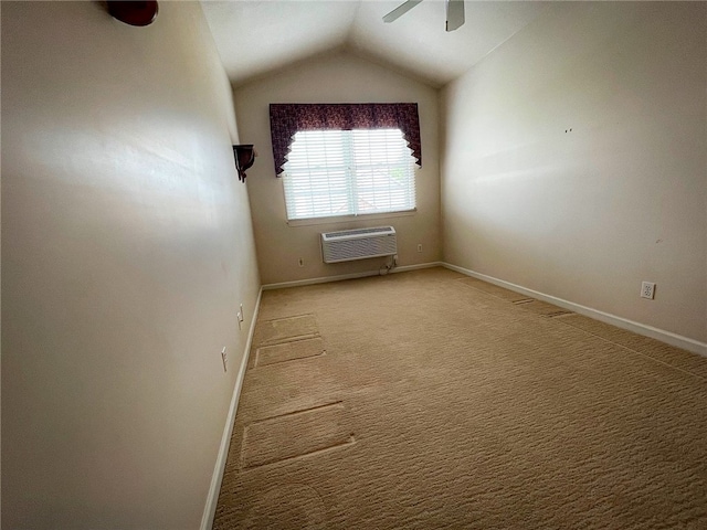 carpeted empty room with lofted ceiling, a wall mounted air conditioner, and ceiling fan